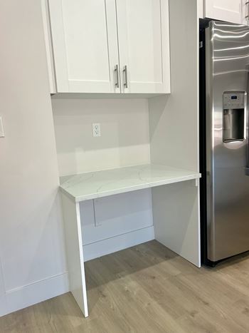 Small desk and cabinets near kitchen